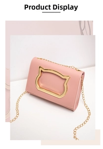 Detail of pink PU leather bag featuring a gold cat head clasp and chain strap