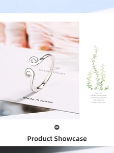 Close-up of minimalist adjustable ring featuring a unique double spiral floral pattern