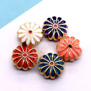 Macro detail of five colorful alloy cloisonne sunflower beads for DIY jewelry making
