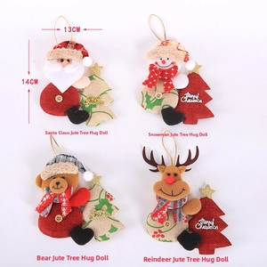 Detail view of four linen Christmas plush figures holding mini Merry Christmas trees
