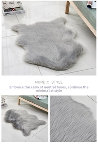Nordic style grey faux fur area rug with a fluffy sheepskin shape on marble floor