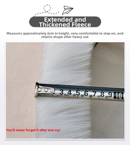Close-up of white shag rug showing 6cm pile height with a measuring tape for scale
