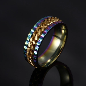 Detail of a rotating golden chain spinner ring with a colorful rainbow plated steel base