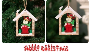 Detail view of laser-cut wooden Christmas tree ornament with reindeer and Merry Christmas sign