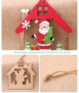 Detail of laser-cut wooden Christmas pendant showing house shape and painted festive elements