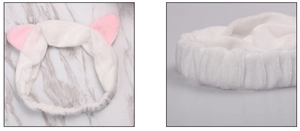 Close-up of white plush cat ear headband with pink details and elastic design for spa
