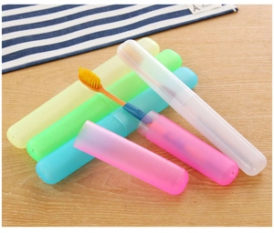 Portable colorful toothbrush travel cases on wood surface with interior storage view