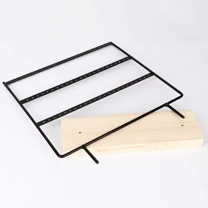 Minimalist iron earring display stand with wood base and black metal perforated frame