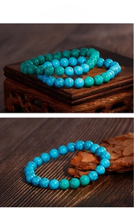 Macro shot of turquoise beaded bracelet with natural black veins on rustic wood