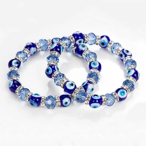 Close-up of Turkish evil eye bracelets with blue beads and sparkling crystal spacers