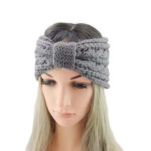 Close-up of grey cable knit headband featuring a chic bow knot design and textured weave