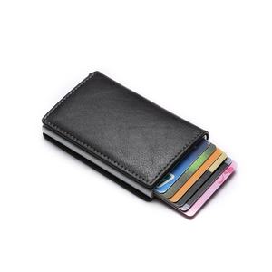 Macro shot of black leather RFID wallet showing card ejection mechanism and fine stitching