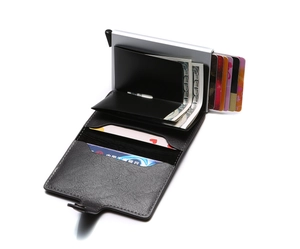 Detail view of the pop-up card holder mechanism and leather interior for cash and cards