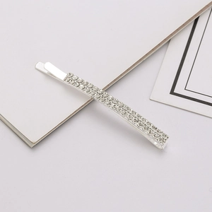 Detailed macro view of silver hair clip with double rows of sparkling rhinestones