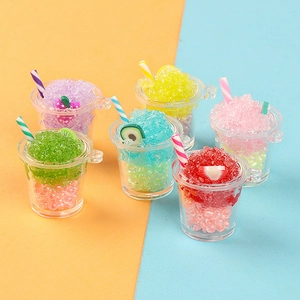 Macro detail of miniature resin fruit smoothie cups with colorful straws and fruit slices
