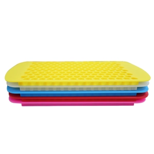 Stacked honeycomb silicone ice cube trays in yellow, white, blue, red, and pink