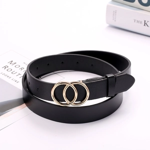 Detail of a minimalist black belt with double golden ring buckle on a white magazine background