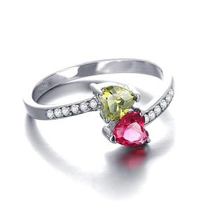Detail view of double heart silver ring with green and rose red gems and S925 hallmark