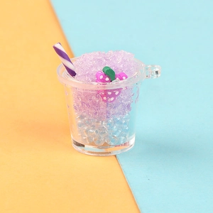 Macro detail of miniature purple grape smoothie cup resin charm with striped straw