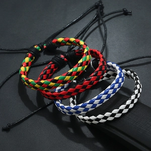 Close-up of four colorful woven leather bracelets with adjustable pull cords