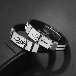 Detail of stainless steel clasp with tribal fire pattern on a flexible silicone bracelet