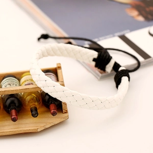 Detailed view of white braided leather bracelet with black adjustable pull cord