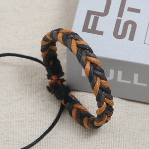 Detail of three-color handmade woven bracelet with adjustable cord on linen background