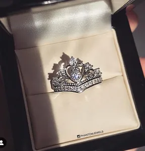 Detailed top view of a silver crown ring with cubic zirconia in a velvet gift box