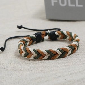 Macro view of handmade braided wax rope bracelet with tri-color cord and adjustable knot