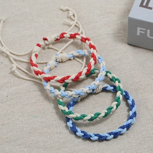 Handmade woven cotton rope bracelets in four colorful dual-tone styles with adjustable knots