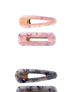 Close-up of acetic acid hair clips set featuring rainbow sequins in resin finish
