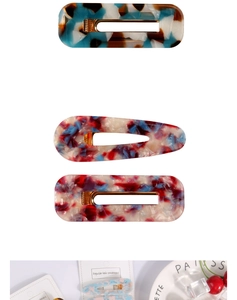 Close-up of hollow acetate hair clips featuring marble textures and gold metal clips
