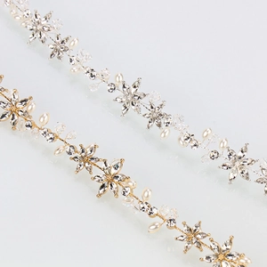 Detail of gold and silver hairbands with intricate crystal flowers and pearl accents