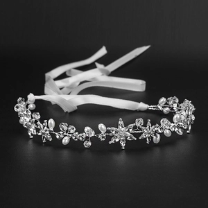 Detailed view of handmade silver bridal headband with crystal flowers and white pearls