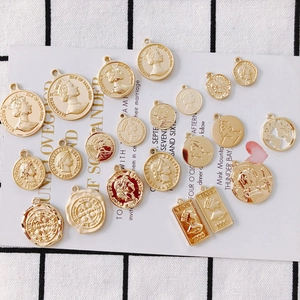 Flat lay of retro golden alloy coin pendants with embossed portraits for DIY jewelry making
