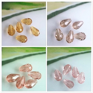 Detail view of faceted teardrop glass beads in champagne and pink for DIY jewelry
