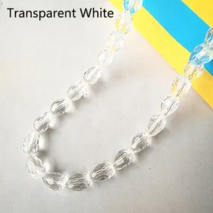 Macro shot of transparent white faceted teardrop crystal glass beads for DIY crafts