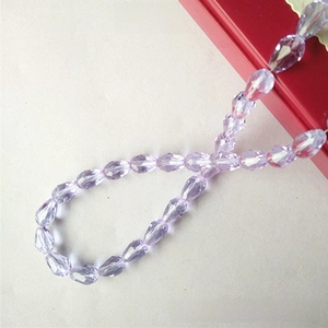 Macro detail of faceted crystal purple glass teardrop beads for DIY jewelry making