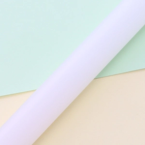 White non-stick PP rolling pin for fondant cake decorating on a pastel background