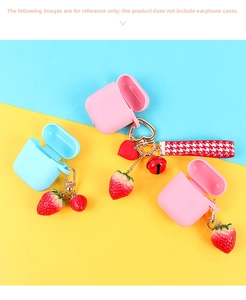 Detail of strawberry keychain with bell, red heart pendant and houndstooth ribbon