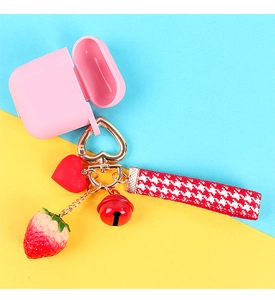 Pink silicone earphone case with cute strawberry charm and red heart bell detail