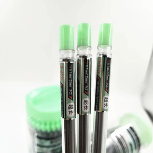 Macro detail of 0.7mm 2B resin pencil leads in transparent tubes with green caps