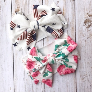 Detail of baby headbands with oversized bows in American flag and floral patterns