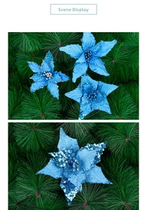 Detail of blue artificial poinsettia with glitter petals on pine branch backdrop