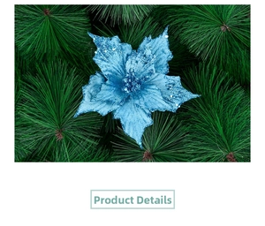 Close-up of blue glitter poinsettia flower head on green pine branches for Christmas decor
