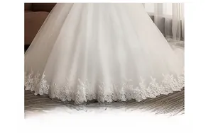 Close-up of white bridal gown train with glittering sequins and delicate wide lace trim