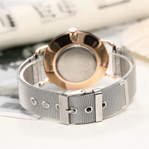 Detail of rose gold case back and silver mesh band with adjustable needle buckle