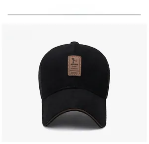 Close-up of black breathable mesh baseball cap with brown leather logo patch