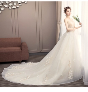Detail of champagne bridal gown with 3D floral embroidery and a long organza train