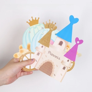 Close-up of glittery castle and pumpkin carriage paper banners for princess party decor